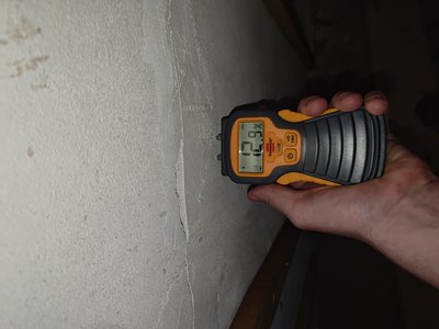 Moisture measurement taken along basement wall — engineering report