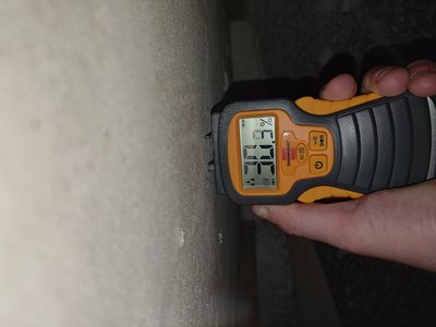 Moisture measurement on basement wall — elevated moisture values registered